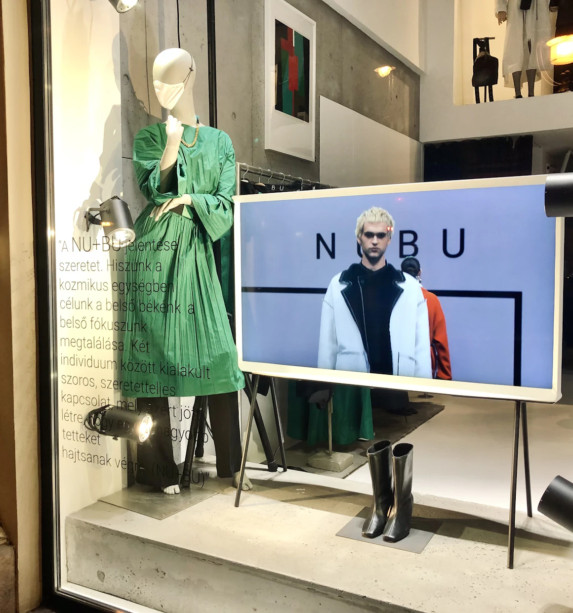 Vitrina de tienda con una pantalla entre los maniquíes